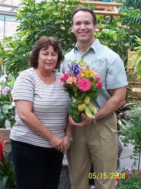 Last years grand prize winner, Leslie Graupner, shown receiving her first bouquet for the year.