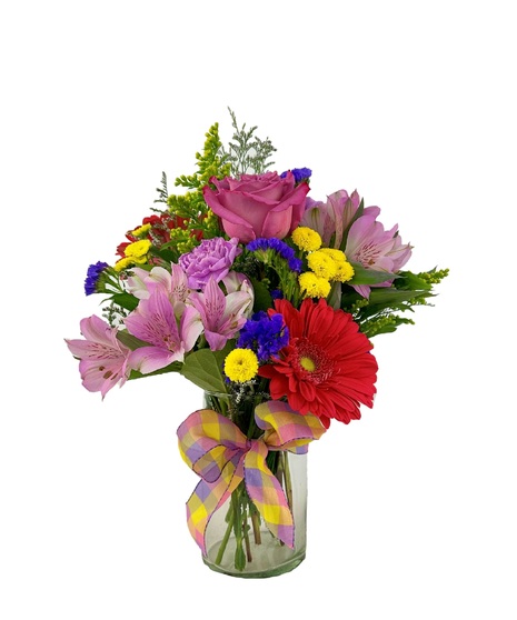 Bright and colorful flowers are arranged in a cylinder vase. 