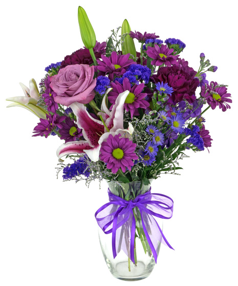 Moddy Blues roses, stargazer lilies,  carnations, daisies and other flowers in hues of purple in a clear glass vase with purple ribbon.