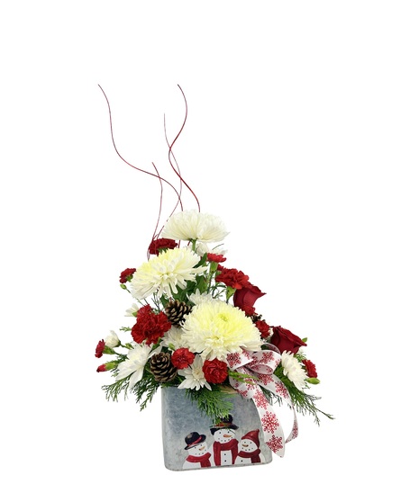 Spider mum and red carnations in a tin with Christmas greens.