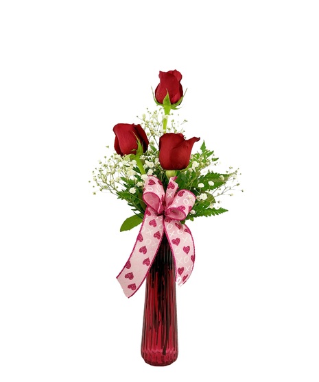 Red or light pink roses, each in a red glass vase with babies breath. 