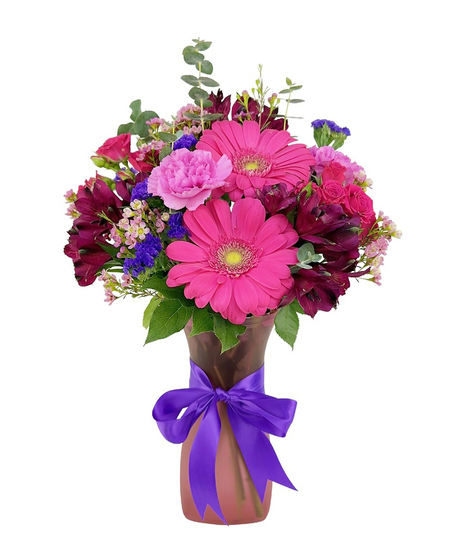 Romantic bouquet in shades of pink and purple, in a pretty purple vase.