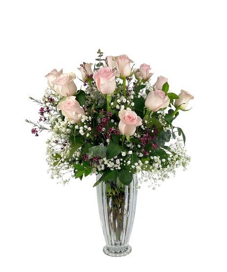 Soft pink long stem pink roses arranged in a Mikasa crystal vase.