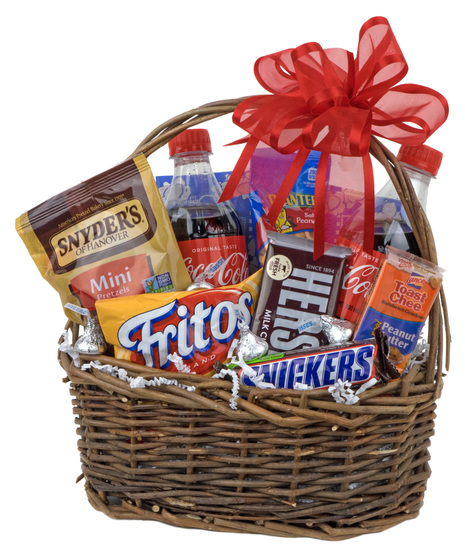 Wicker handled basket filled with candy bars, and snack foods with a red ribbon tied on the handle.