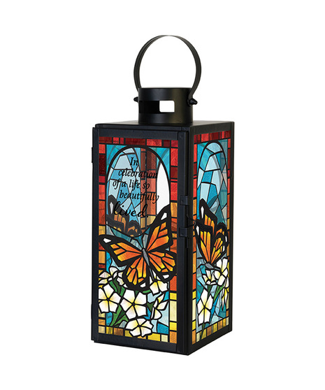 Silhouette lantern has a battery operated flickering candle and artwork imprinted on glass.