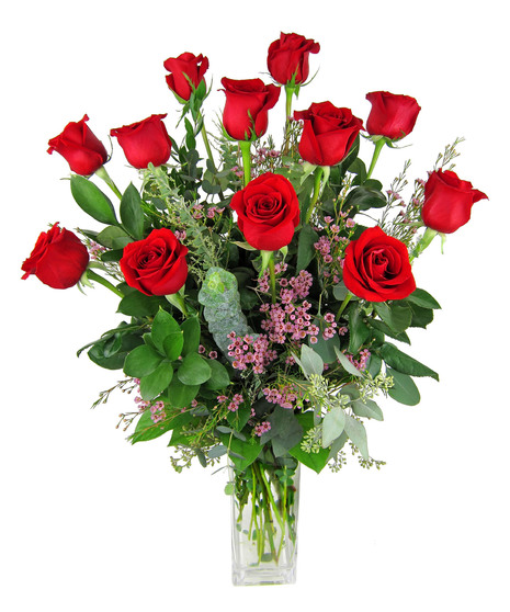 One dozen red roses in a clear glass vase. 