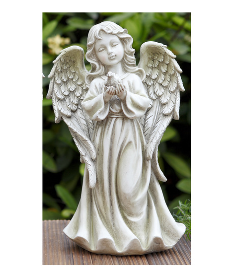 Sweet young girl with a dove resting in her hands.
